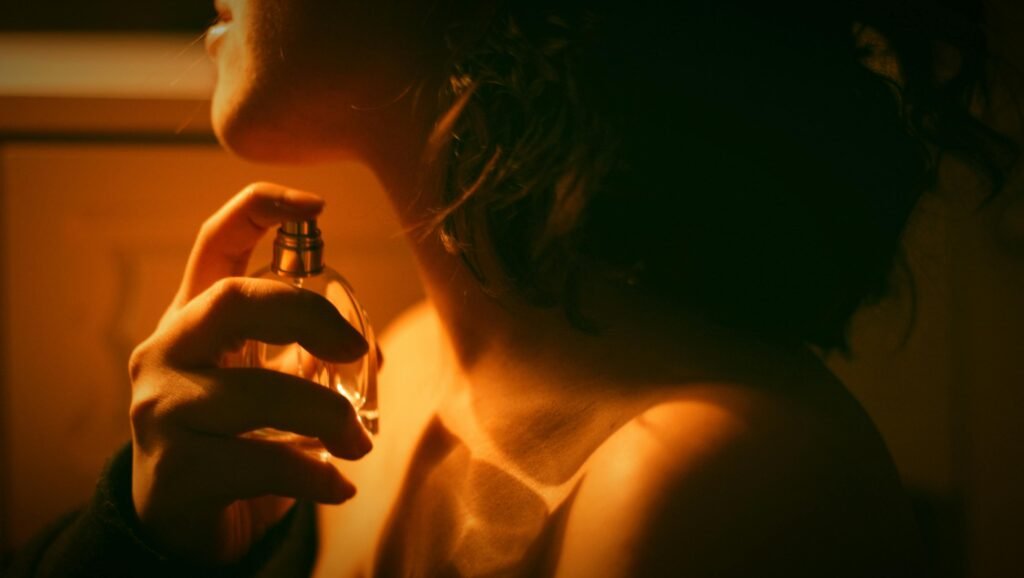 Woman spraying perfume
