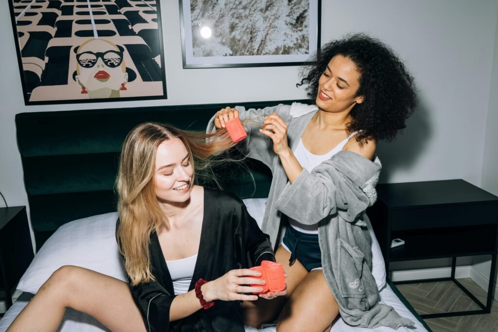 Woman applying rollers in hair Foam rollers for heatles curls